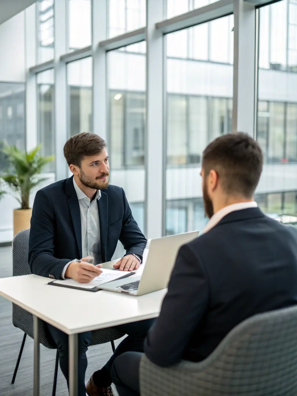 A confident professional participating in a mock job interview, with the interviewer providing constructive feedback.